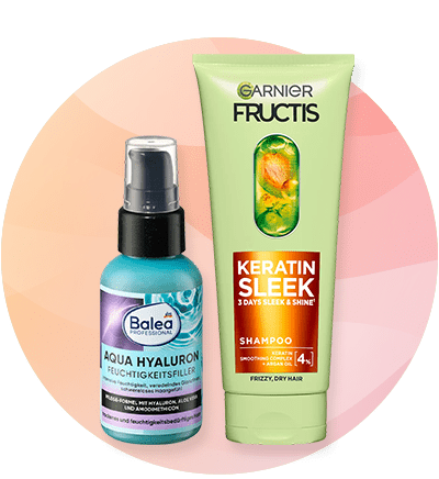 Šampon Garnier Fructis Keratin Sleek i Balea Aqua Hyaluron bočica na pastelnom krugu