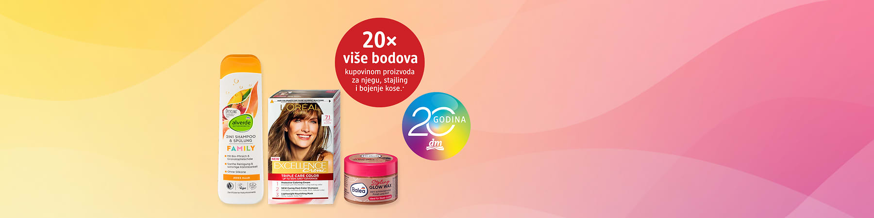 Kutija boje za kosu uz šampon i styling kremu na rozoj pozadini