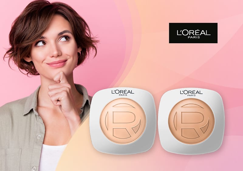 Ženska osoba s kratkom kosom i dva L'Oréal pudera na ružičasto-narančastoj pozadini