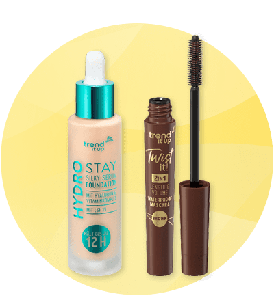 Kosmetické produkty na žlutém kruhovém pozadí: tekutý make-up a hnědá řasenka