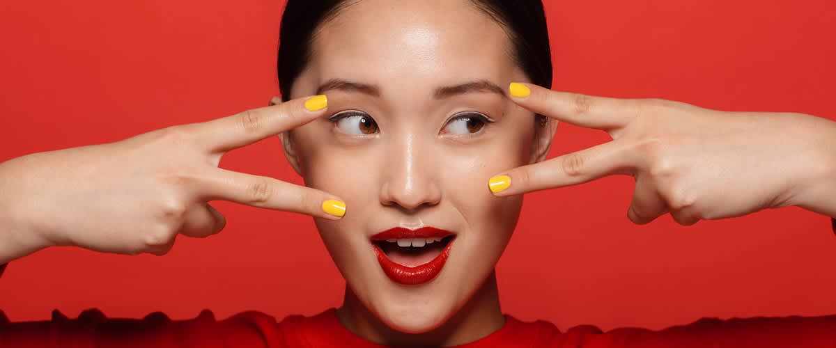 Žena se žlutými nehty a červeným tričkem