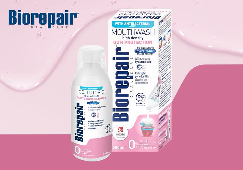 Láhev ústní vody Biorepair a její krabička na růžovém pozadí