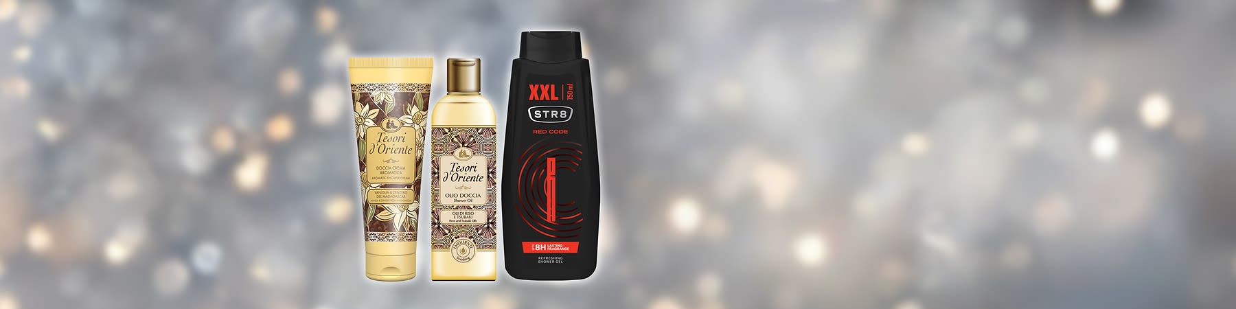 Tři lahve sprchových gelů různých značek na rozmazaném pozadí.