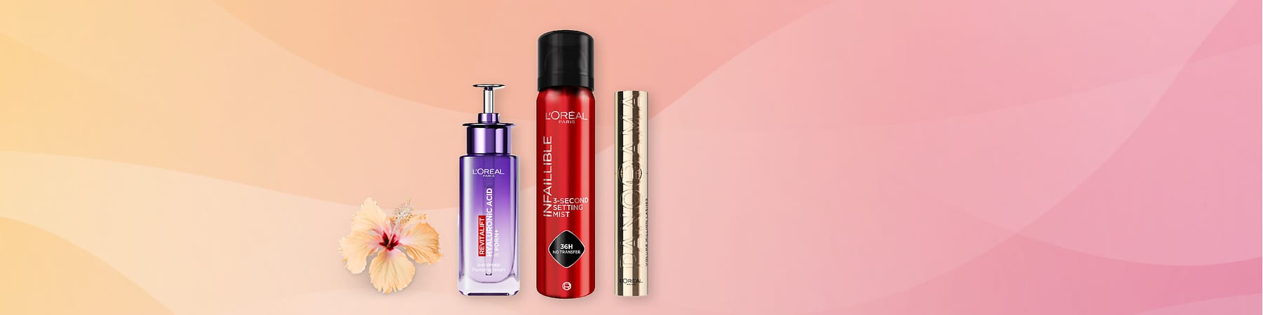 Kosmetické produkty L'Oréal na růžovo-oranžovém pozadí s květem ibišku