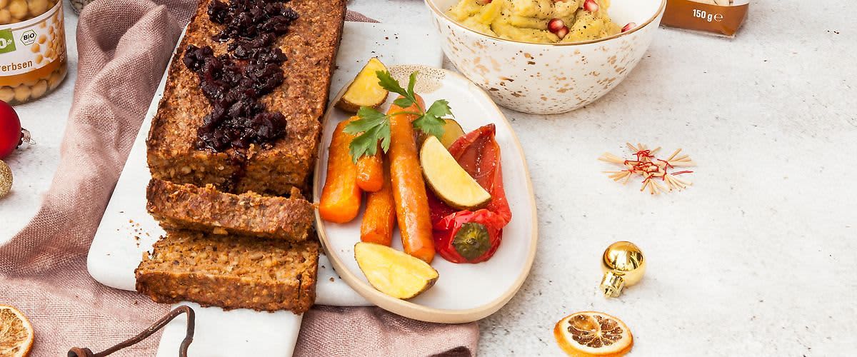 Vegetariánská sekaná s brusinkami, pečená zelenina a brambory na talíři