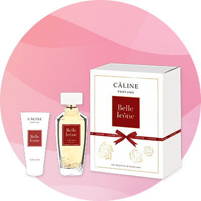 Eine Parfüm- und Handcreme-Geschenkbox von Câline Parfums mit der Aufschrift „Belle Icône“ auf rotem Hintergrund.