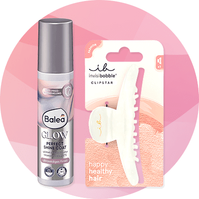 Eine silberne Flasche Balea Glow Perfect Shine Coat neben einer weißen invisibobble Clipstar Haarspange auf rosa Hintergrund