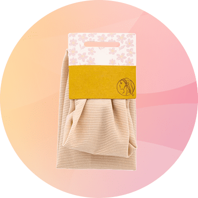 Beige, geripptes Stirnband mit Pappanhänger in Pastellblumenmuster und gelbem Etikett mit Profil-Silhouette einer Frau
