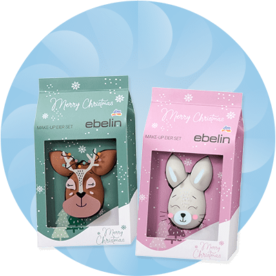 Zwei Make-up-Eier-Sets von ebelin in grüner und rosa Verpackung mit Rentier- und Hasenmotiv, Aufschrift „Merry Christmas“