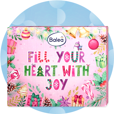 Eine rosa Verpackung mit weihnachtlichen Motiven und der Aufschrift „Fill Your Heart With Joy“ sowie dem Balea-Logo