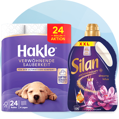 Eine Packung Hakle Toilettenpapier mit der Aufschrift „Verwöhnende Sauberkeit“ und eine Silan XXL Flasche mit „Aromatherapy dreamy lotus“ Design