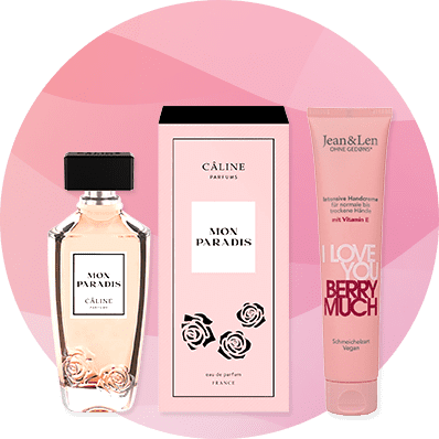 Eine Parfümflasche und Verpackung von Câline Parfums mit der Aufschrift „Mon Paradis“ neben einer Handcreme von Jean & Len mit „I Love You Berry Much“
