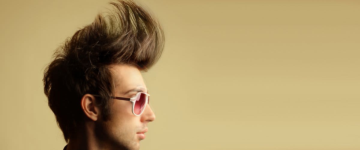 Mann mit hochgestylten Haaren und rosa Sonnebrille