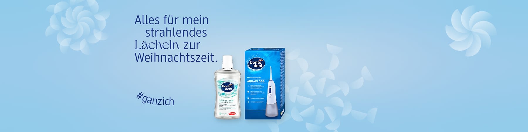 Eine blaue Verpackung der Dontodent Aquafloss neben einer Dontodent Sensitive Mundspülung. Text: „Alles für mein strahlendes Lächeln zur Weihnachtszeit“ und „#ganzich“