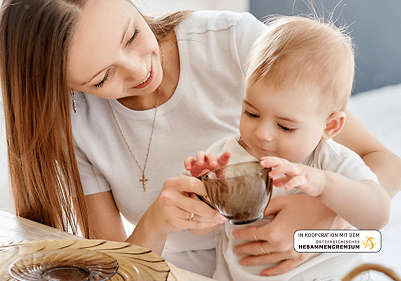Mama, Baby und Becher mit Tee