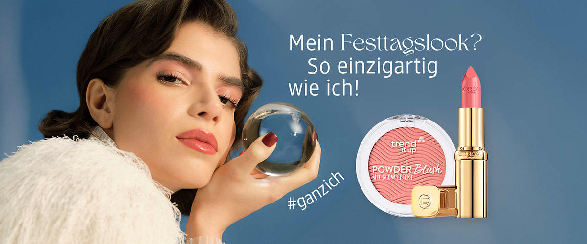Eine Frau hält eine gläserne Kugel, daneben ein rosa Lippenstift und ein runder Blush mit der Aufschrift „trend it up POWDER Blush“ auf blauem Hintergrund, darüber der Text „Mein Festtagslook? So einzigartig wie ich!“ und darunter „#ganzich“