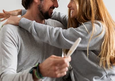 Glückliches Pärchen mit Schwangerschaftstest