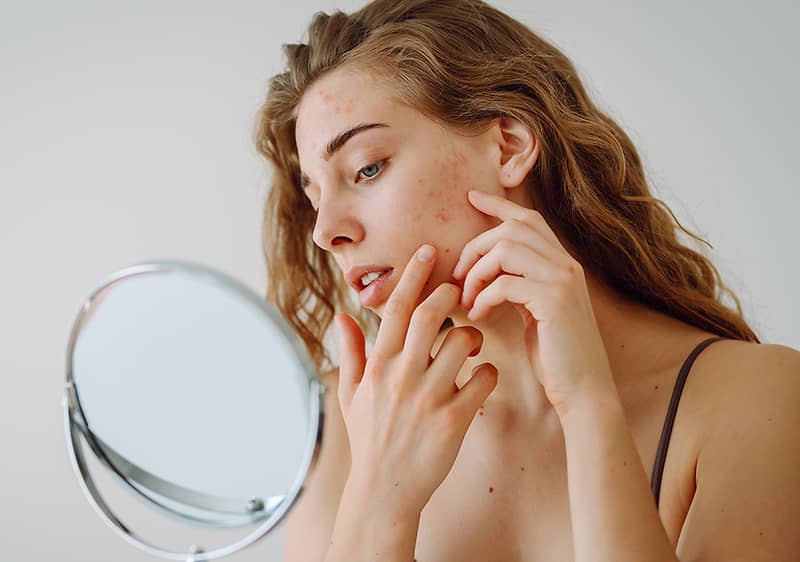 Frau mit lockigem Haar vor einem Spiegel