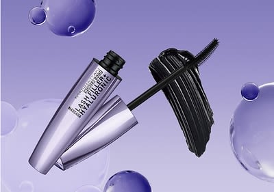 Mascara mit Bürste und violetter Verpackung auf lila Hintergrund