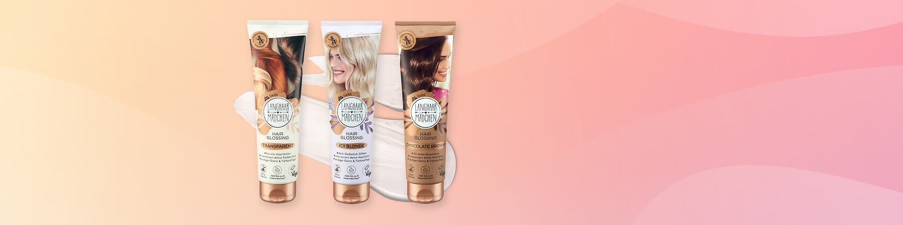 Drei Hair Glossing Tuben von Langhaarmädchen auf rosa Hintergrund