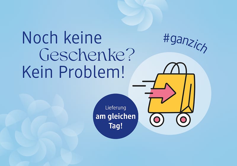 Hellblauer Hintergrund mit dem Text „Noch keine Geschenke? Kein Problem! Lieferung am gleichen Tag!“ und einem gelben Einkaufswagen mit rotem Pfeil, daneben der Hashtag #ganzich