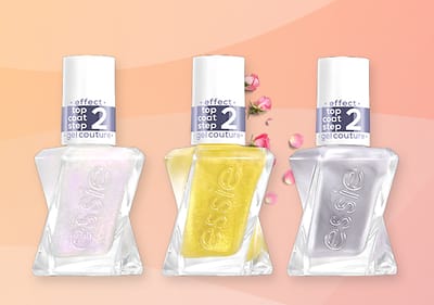 Drei Essie Nagellackflaschen in Rot, Grün und Klar mit den Aufschriften „nail color step 1“ und „effect top coat step 2“ auf einem rosa Hintergrund