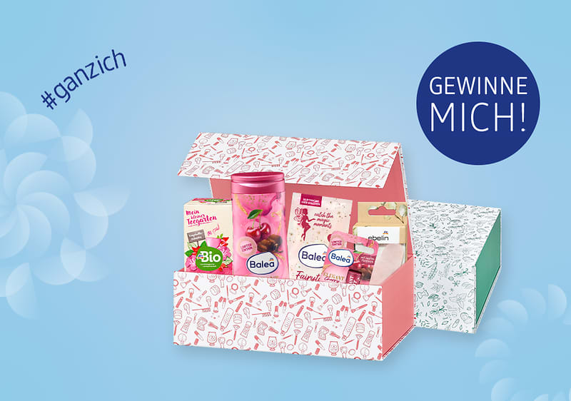Eine geöffnete Geschenkbox mit Balea-Produkten, daneben der Text „GEWINNE MICH!“ und „#ganzich“ auf blauem Hintergrund