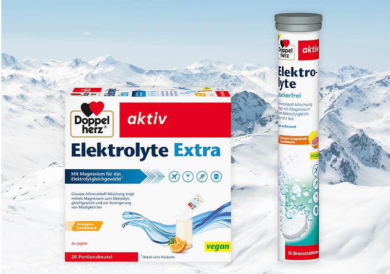 Zwei Produktverpackungen von Doppelherz: links eine Packung mit der Aufschrift „Elektrolyte Extra“, rechts eine Tube mit „Elektrolyte Zuckerfrei“