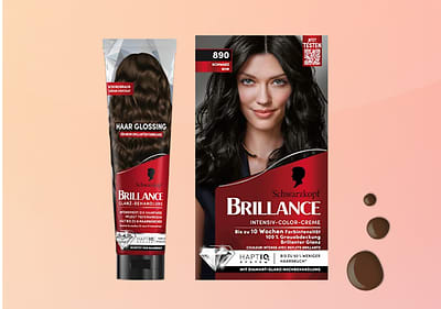 Eine rote Verpackung von Schwarzkopf Brillance Haarfarbe mit der Aufschrift „Intensiv-Color-Creme 890 Schwarz“ und „Haar Glossing“ auf der Tube