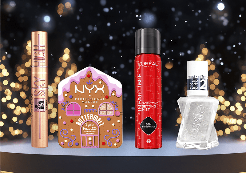 Vier Kosmetikprodukte vor einem verschwommenen Hintergrund mit Lichtern: Maybelline Sky High Mascara, NYX Butter Gloss Palette, L'Oréal Infallible Setting Mist, Essie Top Coat