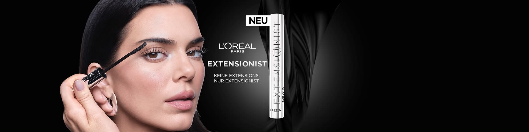 Eine schwarze Werbegrafik für L'Oréal Paris mit einem silbernen Produkt, das als „Extensionist“ bezeichnet wird. Text: „Keine Extensions, nur Extensionist“ und „NEU“.