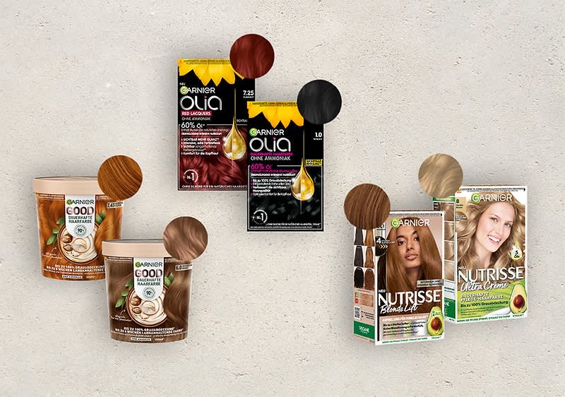 Mehrere Haarfärbemittel von Garnier, darunter Olia und Nutrisse, in verschiedenen Farbtönen. Verpackungen zeigen Farbproben und Inhaltsstoffe wie Avocadoöl.