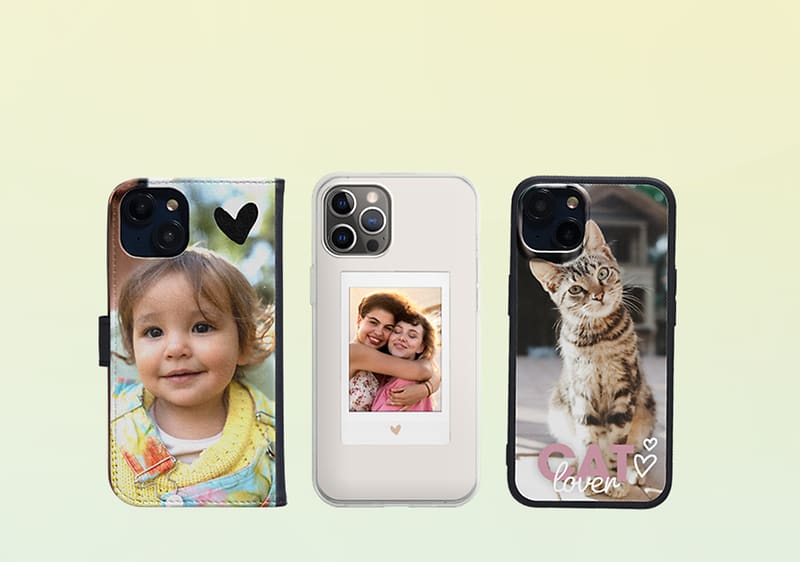 Drei Handyhüllen nebeneinander: links eine Hülle mit Herzmotiv und einem Kind mit gelbem Pullover (Gesicht ausgeblendet), Mitte eine transparente Hülle mit einem Polaroid-Foto zweier umarmender Personen und einem kleinen Herz darunter, rechts eine Hülle mit Foto einer sitzenden getigerten Katze und dem Schriftzug „CAT lover“