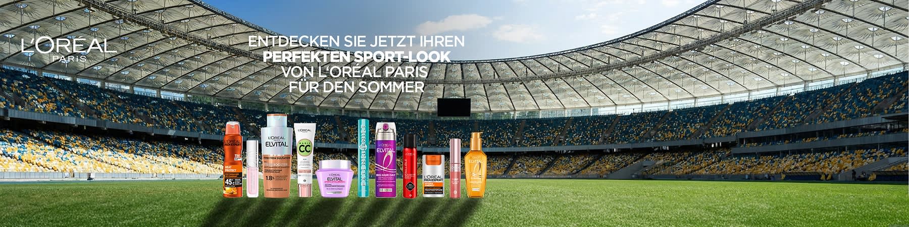 Mehrere L’Oréal- und Elvital-Produktflaschen und -tuben in einer Reihe vor einem Stadionhintergrund, darüber Text „ENTDECKEN SIE JETZT IHREN PERFEKTEN SPORT-LOOK FÜR DEN SOMMER VON L’ORÉAL PARIS“