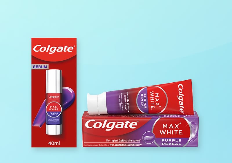 Rote Colgate-Verpackung links mit silberner Serumflasche, Schriftzug „Colgate“ und „40ml“, daneben liegend rote Zahnpastatube „Colgate MAX WHITE PURPLE REVEAL“ auf violetter Kartonverpackung mit gleichem Schriftzug und tropfenförmigem violettem Design