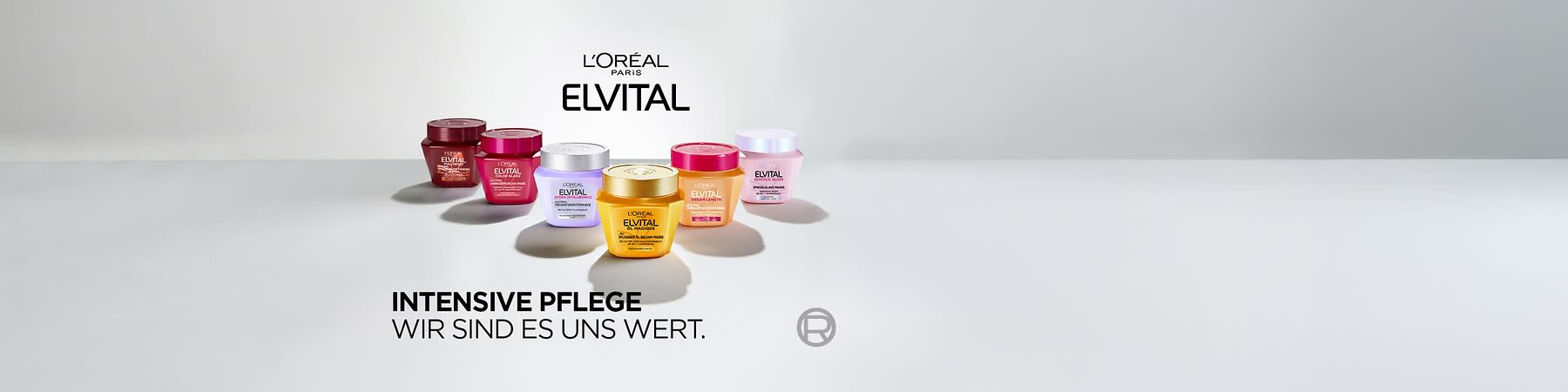 Sechs bunte Elvital-Haarpflege-Tiegel von L’Oréal Paris in zwei Reihen auf hellem Untergrund, Markenname „L’ORÉAL PARIS ELVITAL“ oben und Slogan „INTENSIVE PFLEGE WIR SIND ES UNS WERT“ links unten ohne Punkt