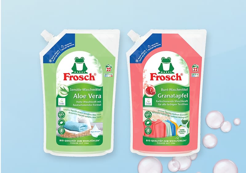Zwei stehende Nachfüllbeutel der Marke Frosch nebeneinander auf hellblauem Hintergrund, links grüner Sensitiv-Waschmittelbeutel mit Aufschrift „Aloe Vera“ und Bild von Handtüchern, rechts rosa Bunt-Waschmittelbeutel mit Aufschrift „Granatapfel“ und Bild bunter Kleidung, beide mit Frosch-Logo oben und Dosierangabe für 22 Wäschen