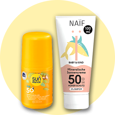 Eine gelbe Sonnenroller-Flasche von Sundance Kids mit Lichtschutzfaktor 50+ und eine weiße Tube Naïf Baby & Kind Mineralische Sonnencreme mit Lichtschutzfaktor 50 und 100 ml