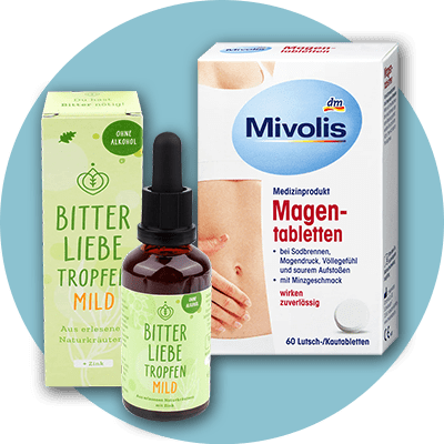 Eine Verpackung von Bitter Liebe Tropfen Mild mit grüner Schrift und ein Mivolis Magentabletten-Karton mit roter und blauer Schrift sind nebeneinander abgebildet.
