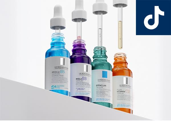 Vier bunte Seren in Glasflaschen mit Pipetten (blaues Hyalu B5, lila Mela B3, grünes Effaclar, orangenes Vitamin C2) nebeneinander, rechts oben TikTok-Logo