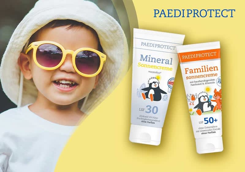 Zwei Sonnencreme-Tuben der Marke PAEDIPROTECT vor gelbem Hintergrund: links weiße Tube mit Aufschrift „Mineral Sonnencreme LSF 30“ und Pinguin-Illustration, rechts weiße Tube mit orangefarbener Kopfzeile „Familien sonnencreme LSF 50+“ mit Pinguin- und Tier-Illustrationen