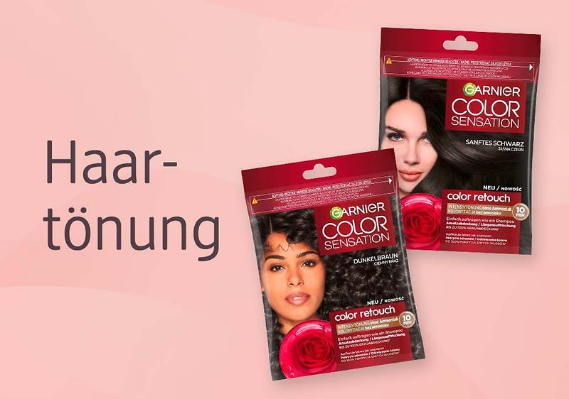 Zwei rote Packungen Garnier Color Sensation Color Retouch Haarfärbemittel in den Farben dunkelbraun und sanftes schwarz neben dem Schriftzug „Haartönung“