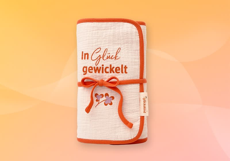 Ein grünes Still- und Kuscheltuch