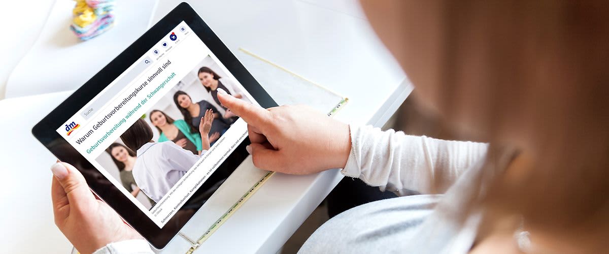 Frau liest Artikel über Geburtsvorbereitung auf dem tablet