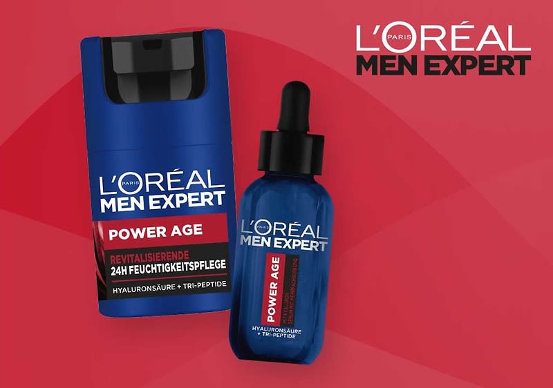 Zwei blaue L'Oréal Men Expert Produktverpackungen vor rotem Hintergrund: links eine Pumpflasche mit Aufschrift „Power Age 24H Feuchtigkeitspflege“, rechts eine Pipetten-Flasche mit Aufschrift „Power Age“ und zusätzlichem Text „Hyaluronsäure + Tri-Peptide“