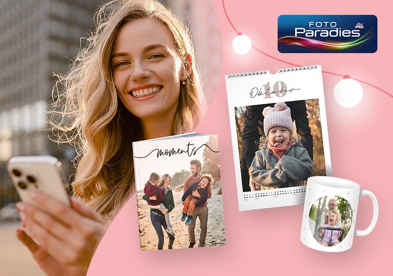 Eine Frau mit einem Smartphone, daneben ein Fotobuch mit einem lachenden Paar und Kind, ein Kalender mit einem Babyfoto und eine Tasse mit einem Kindergesicht, oben rechts das Logo von Foto Paradies