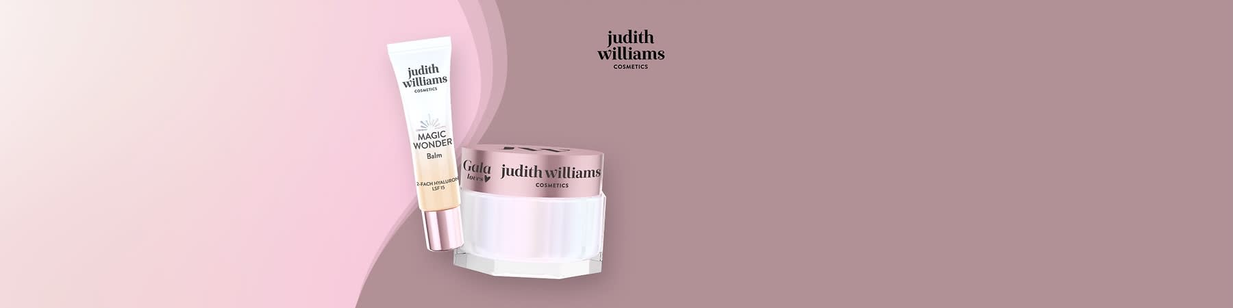 Eine Tube mit der Aufschrift „Magic Wonder Balm“ und ein Tiegel mit rosafarbenem Deckel, beide von Judith Williams Cosmetics, auf einem hellen Hintergrund