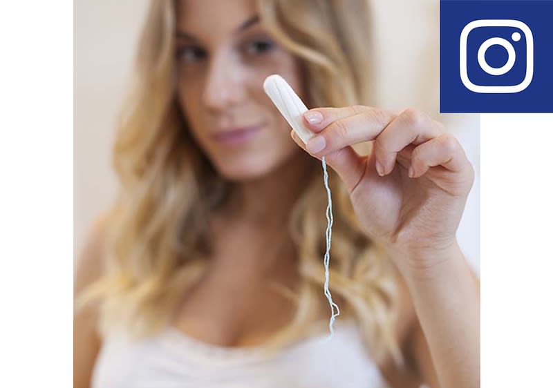 Frau hält Tampon in der Hand
