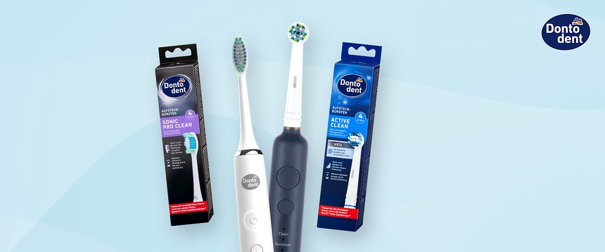 Zwei elektrische Zahnbürsten von Dontodent, eine in Weiß und eine in Dunkelblau, stehen vor ihren Verpackungen mit der Aufschrift „Sonic Pro Clean“ und „Active Clean“