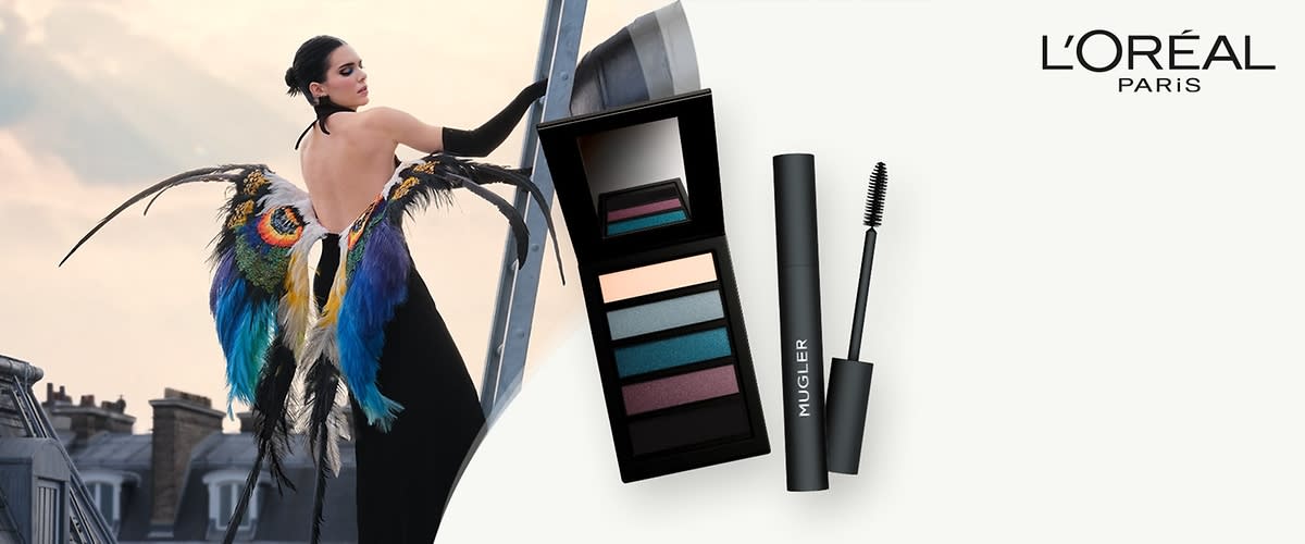 Eine schwarze Lidschattenpalette mit fünf Farben und ein schwarzer Mascara mit der Aufschrift „MUGLER“ daneben, oben rechts das Logo von L'Oréal Paris